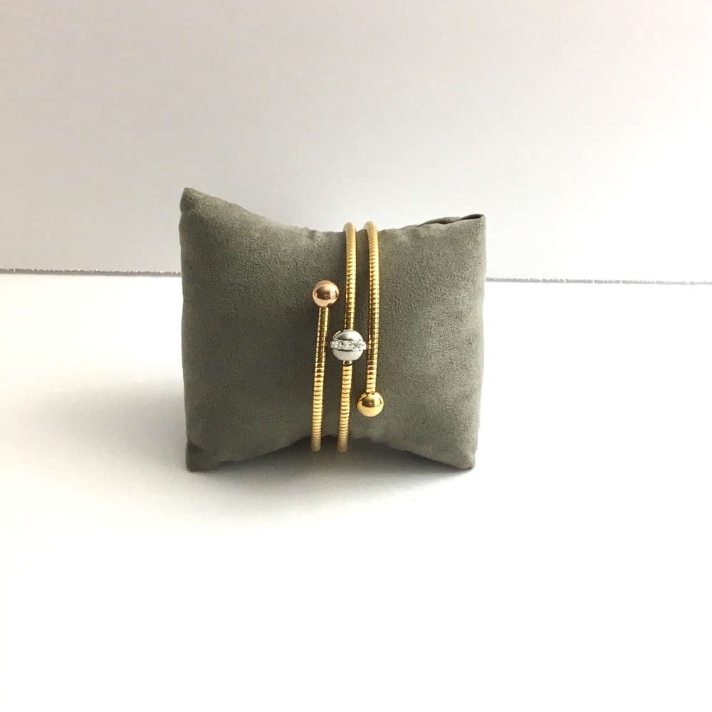 Featuring Three Handcrafted Gold Stainless Steel .